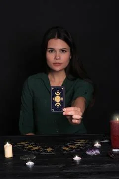 Soothsayer predicting future at table against black background, closeup. Fo.. 写真素材