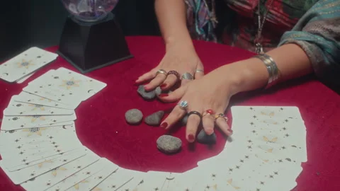 Soothsayer Taking One Rune Stone and Showing to Client Stock Footage 253181913