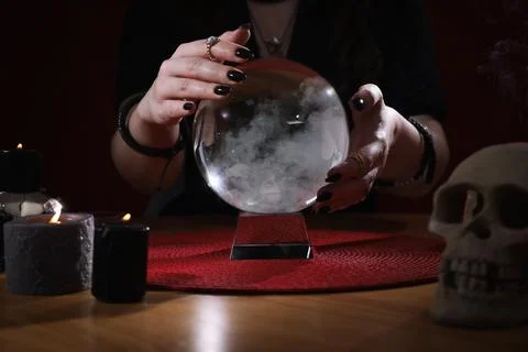 Soothsayer using crystal ball to predict future at table indoors, closeup 스톡 사진