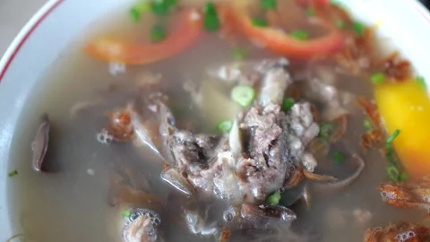 Sop Iga (Beef ribs soup) is Indonesian soup. served in white bowl. selective foc Stock Footage 255185298