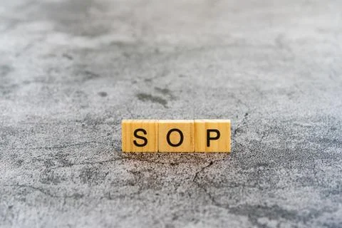 SOP (Standard Operating Procedure) text on wooden block textures background Stock Photos