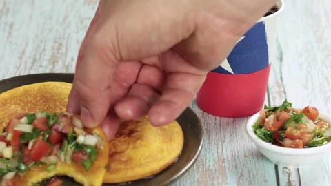 Sopaipillas with bite, hand grabbing, of squash or pumpkin and placing pebr.. Stock Footage 244964680