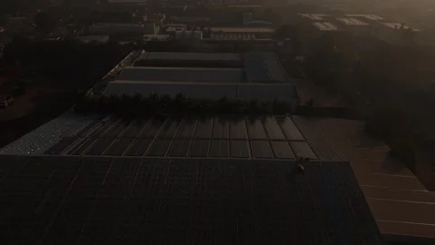 A sophisticated array of dark blue solar panels installed across the vast roof Stock Footage 334289988