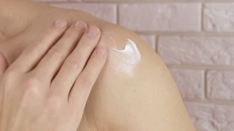 Sore shoulder. Rubbing the ointment on the shoulder. Stock Footage