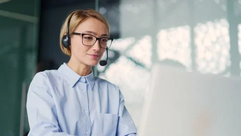 Сorporate operator who works in the support service speaks on a video call using Stock Footage 239026525