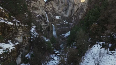 Sorrosal Waterfall among snowy cliffs and forest in Pyrenees Stock Footage 341524968