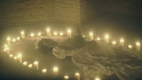 Sorrow scene of a corpse bride on the floor like a ritual with candles Stock Footage 69171180