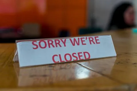 Sorry we are closed tabletop sign on wooden counter Photos