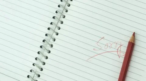 Sorry written on open notebook. Closeup. Mistake learning, blooper, regret sa Stock Photos