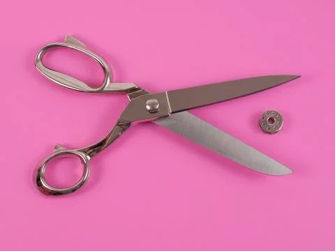 Sors and spools of thread on pink background Stock Photos