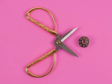 Sors and spools of thread on pink background Stock Photos