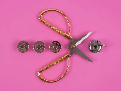 Sors and spools of thread on pink background Stock Photos