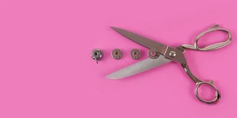 Sors and spools of thread on pink background Stock Photos
