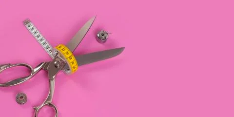 Sors and spools of thread on pink background Stock Photos