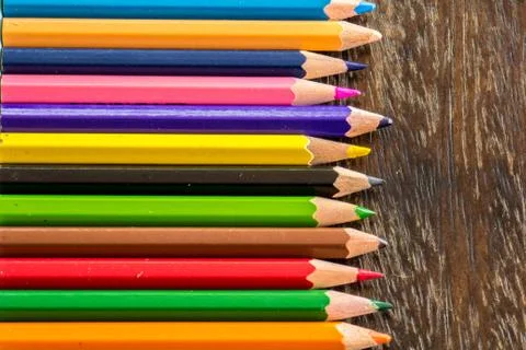 Sort crayons flooring surfaces, bright colors, red, yellow, black, orange and Stock Photos