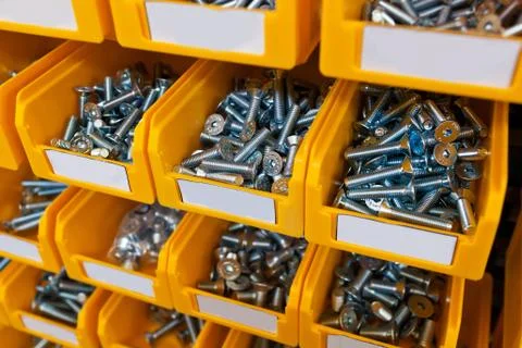 Sorted bolts in boxes in the store Stock Photos