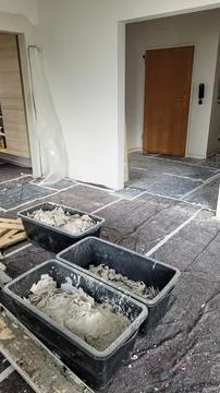 Sorted construction garbage on a protected floor in the middle of the room Stock Photos