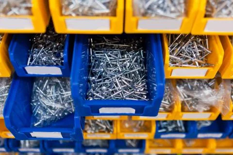 Sorted rivet in boxes in the store Stock Photos