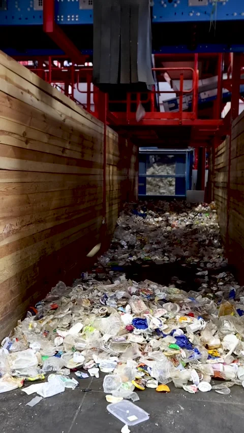 Sorted waste discharged into ground collection zone in recycling facility Stock Footage 333345321