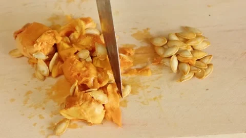 Sorting and cleaning fresh pumpkin seeds from raw pulp for future planting .. Vídeo Stock 337952909