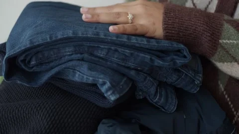 Sorting and organizing clothes at home for better storage Stock Footage 336984870