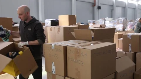 Sorting and packing the goods to send them to Ukraine in Cracow, Poland Stockbeeldmateriaal 172101974