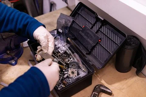 Sorting and Selecting Metal Fasteners and Parts from Toolbox in Workshop 스톡 사진