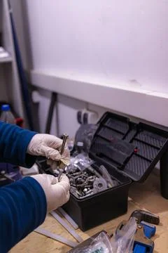 Sorting and Selecting Metal Fasteners and Parts from Toolbox in Workshop 스톡 사진