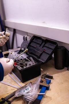 Sorting and Selecting Metal Fasteners and Parts from Toolbox in Workshop 스톡 사진