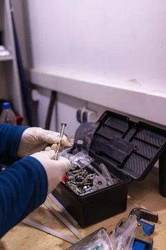 Sorting and Selecting Metal Fasteners and Parts from Toolbox in Workshop 스톡 사진