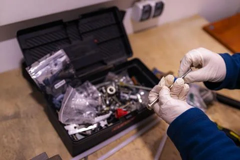 Sorting and Selecting Metal Fasteners and Parts from Toolbox in Workshop 스톡 사진