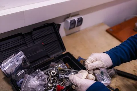 Sorting and Selecting Metal Fasteners and Parts from Toolbox in Workshop 스톡 사진