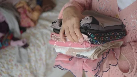 Sorting clothes at home in the afternoon Stock Footage 335798872