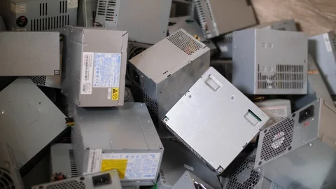 Sorting computer components for recycling. Close up of power supplies stack Stock Footage 105644605