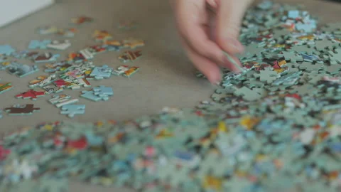 Sorting the edge pieces of a jigsaw puzzle Stock Footage 224535213