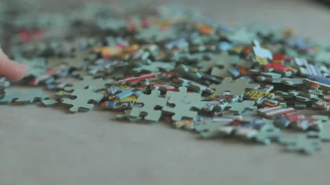 Sorting the edge pieces of a jigsaw puzzle Stock Footage 224535464