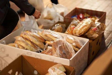 Sorting fresh bread in boxes, humanitarian food aid Stock Photos