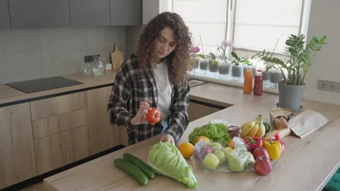 Sorting Fresh Vegetables On Kitchen Counter After Grocery Shopping Trip Video stock 311283416