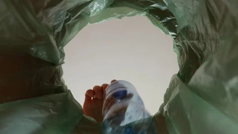 Sorting the garbage in the kitchen , a girl throws a bottle. Stock Footage 306090632