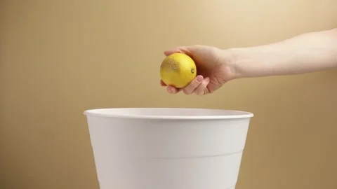 Sorting garbage, lemon thrown in trash, composting initiative, eco-friendly.. Stock Footage 271662918