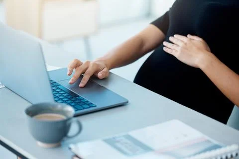 Sorting her emails before she leaves. Closeup shot of a pregnant businesswoman Stock Photos