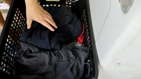 Sorting Laundry Clothes in a Black Basket for Washing Video stock 305167329