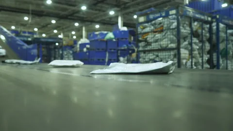 Sorting mail packages at the factory. Linear conveyor at the factory. Mail Stock Footage 148312878