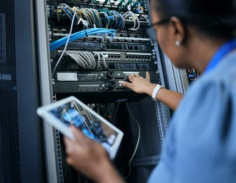 Sorting out network issues. Rearview shot of an unrecognizable female program Stock Photos