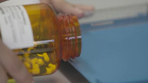 Sorting Pills from bottle to tray Stock Footage 65042187