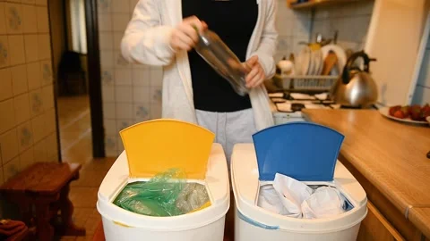 Sorting plastic bottle into yellow recycling bin 스톡 동영상 336684946