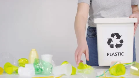 Sorting Plastic Cups And Straws To Container Stock Footage 141520567