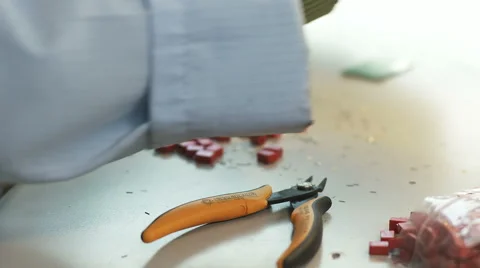 Sorting small electronic parts on a workbench Stock Footage 68838435