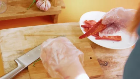 Sorting split red chili pepper pieces beside a chef knife, 4K Video stock 341122444