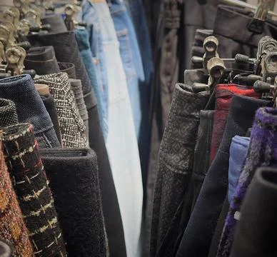 Sorting through reused clothing items in a sustainable fashion store Stock Photos